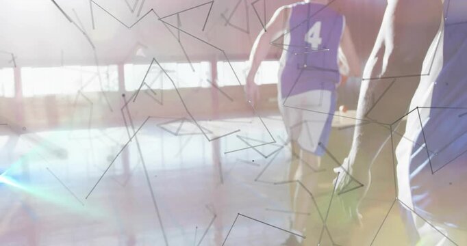 Camera pulling back revealing male #4 dribbling orange ball to score in sports gym overlays flaring