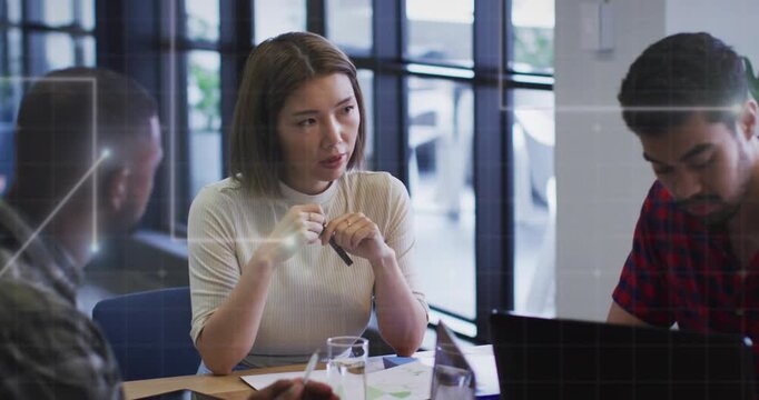 Center woman tapping pen and speaking, initiating grid overlay over laptop during business meeting