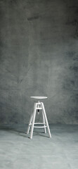 White stool on a A high-resolution textured gray studio backdrop with subtle gradients and painterly details. Ideal for portrait photography, product shoots, graphic design compositions