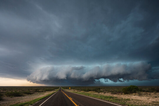 Tracking a Supercell alomg Texas Highway 285, grey cloud formations hovering over the land. 