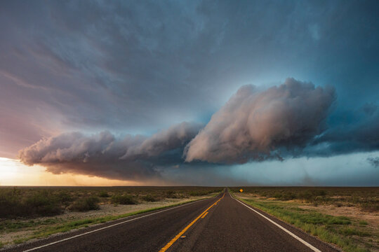 Tracking a Supercell alomg Texas Highway 285, grey cloud formations hovering over the land. 
