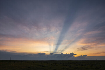 Anti-Crepuscular Rays at Sunset, beams of light radiating from the horizon.