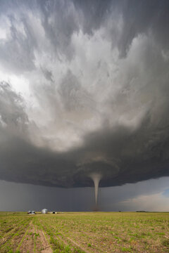 Fully Condensed Tornado, a rotating column of air reaching to the ground, a defined shape. 