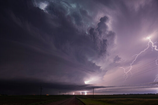 Fully Developed Wedge Tornado on the Ground after Sunset with  Lightning in the Supercell
