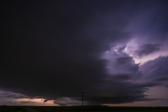 Fully Developed Wedge Tornado on the Ground after Sunset with  Lightning in the Supercell