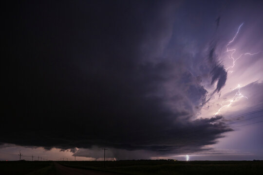 Fully Developed Wedge Tornado on the Ground after Sunset with  Lightning in the Supercell