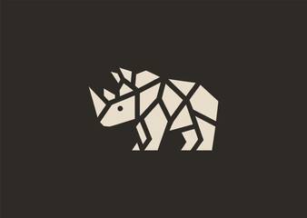 Obraz premium A strong geometric rhinoceros logo formed with sharp polygonal contours and structured line blocks, symbolizing power, protection, and resilience in a clean minimalist vector style