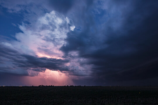 Approaching Storm with Lightning, a sky of black and grey clouds, and lightning lighting up the clouds. 