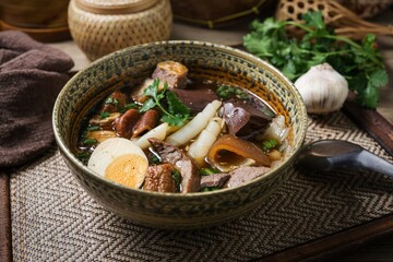 Chinese rolled noodles with crispy pork and egg in black soup,Rolled Rice Noodles in Five-spices Broth , Chinese noodles, thai called kuay jap