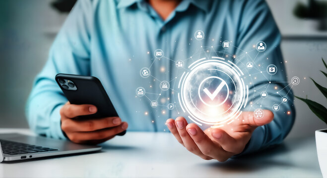 A man in a blue shirt holds a smartphone in one hand while the other hand displays a digital checkmark, symbolizing approval, validation, and successful task completion