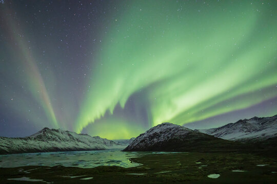 Aurora Borealis, the natural light display in the sky caused by charged particles from the sun colliding with gases in Earth's atmosphere, northern lights.
