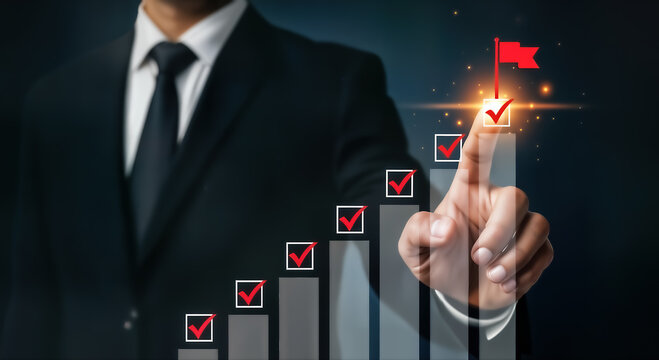 A businessman in a suit is pointing to a bar graph with check marks on each bar, leading to a red flag at the top, symbolizing success and achievement of goals