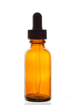 Close-up of an empty dropper bottle on a white background.