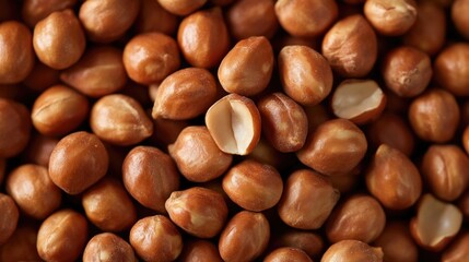 A close-up of peanuts in their shells, showcasing their natural texture and color.