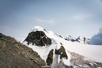 Snow-covered Mt. Breithorn on border of Italy and Switzerland on a clear alpine day, showcasing dramatic peaks, glaciers and panoramic views of the Swiss Alps