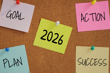 5 post-it paper pin on board with number 2026 in the middle and word goal, plan, action, success around. new year goal target concept