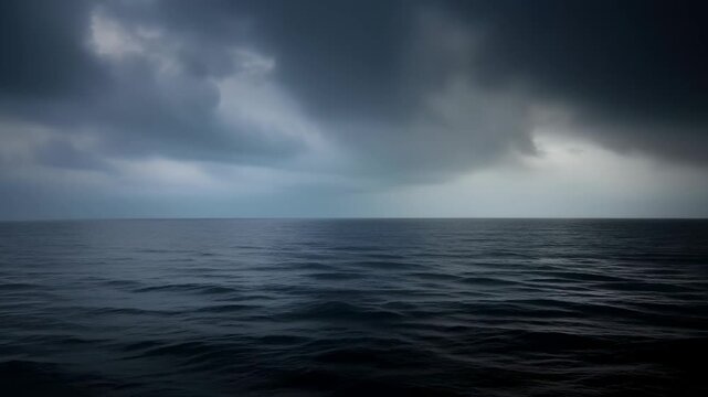 Dark stormy ocean surface with foreboding clouds. Cloudy sky over vast sea. Moody weather condition scene footage.