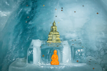 Ice statue of Gautam Buddha inside a glacial tunnel at Matterhorn Glacier Paradise, Zermatt, surrounded by shimmering ice and alpine atmosphere.