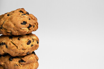Light background with delicious cookies. Cookies with raisins and nuts on white background. Photo for article, blog and recipe or food post.