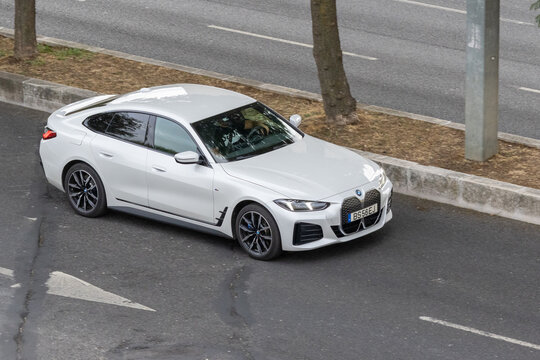 White bmw i4 electric sedan driving on road