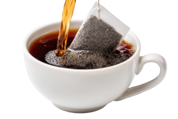 Tea bag steeping in a cup.  Hot liquid pours into a white teacup.  Dark tea filling the cup, small air bubbles.  Close-up view