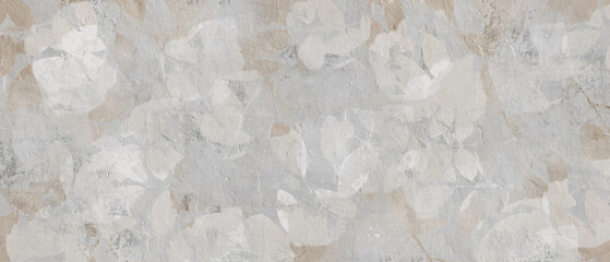 Soft beige and white floral patterns over a rough grey painted wall creating a textured artistic abstract background.