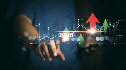 Hand interacting with futuristic 2026 digital interface showing rising arrows and business analytics, representing strategic planning, growth opportunities, and technology-driven financial development