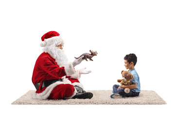 Santa claus playing with a boy on a carpet