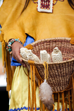 Santa Fe, New Mexico, United States. Indian Market. White Mountain Apache woman with basket of corn 