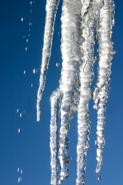Santa Fe, New Mexico, USA. Frozen icicle melting against a sunny blue sky in winter 
