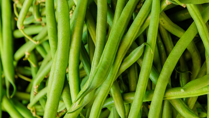 Fresh green French beans displayed at a vibrant market stall in Kenya, highlighting healthy tropical vegetables and local farm-to-market produce