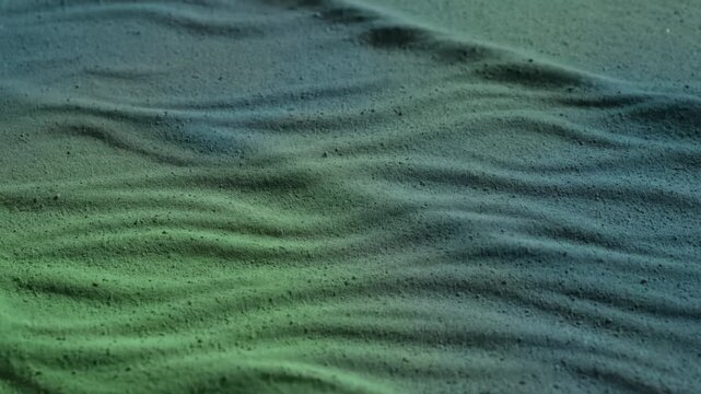 Abstract Sand Surface Waving in Green and Blue Gradient Light Pattern