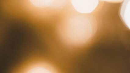Soft brown and golden bokeh lights creating warm festive holiday atmosphere vibe.