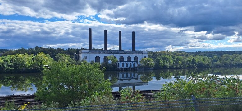 An old rustic factory sitting on a river in upstate New York with dramatic skies.