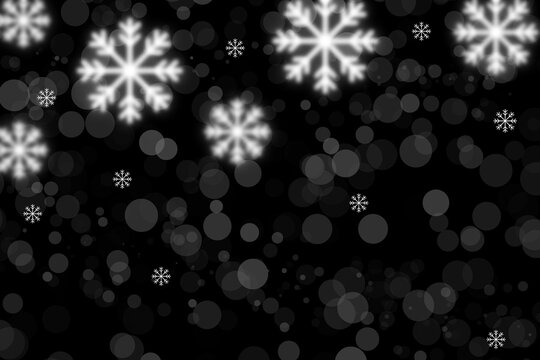 Falling snowflakes and bokeh lights on black background