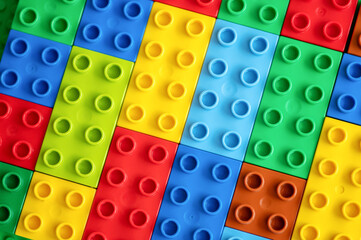 Naklejka premium Colorful plastic building blocks background. Top view. 