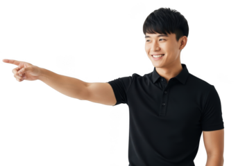 Young asian man wearing a black polo shirt pointing to the left with a smile isolated on transparent background