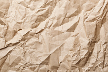 Crumpled brown kraft paper background creating textured surface