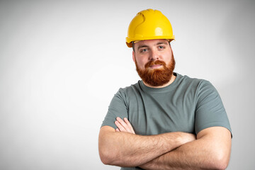 Handsome man industrial engineer wearing a yellow helmet solated on white background
