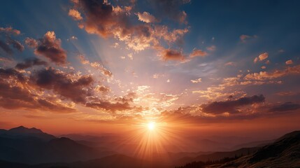 Majestic sunburst at sunset over layered mountain ranges under  dramatically clouded sky with warm orange and blue tones