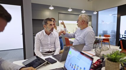 Capturing the dynamic interaction of business colleagues as they discuss projects and share insights in a contemporary office. - Powered by Adobe