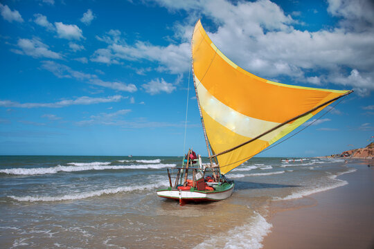 Jangada, or raft, a rustic wooden boat with a sail, typically used for fishing and recently for excursions with tourists. Canoa Quebrada Beach, CE, Brazil, 2019