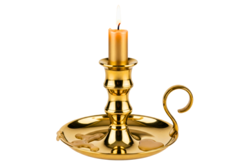 Lit wax candle in a vintage brass chamberstick candle holder isolated with transparent background