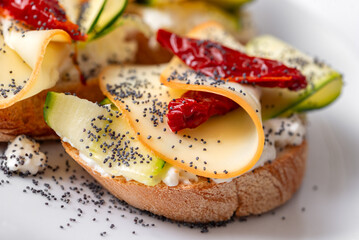 Bruschette con crema di formaggio, zucchine e fette di provola affumicata, spuntino vegetariano 