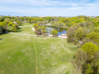 Aerial view from the drone of a green public park with a pond