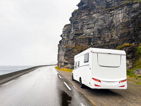Camper van traveling on the e69 road to nordkapp, norway, on a rainy and foggy day