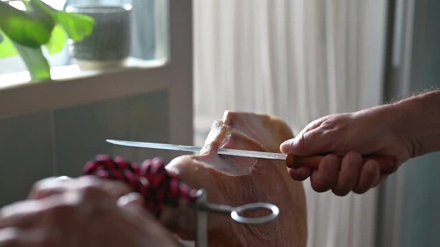 Trimming Rind to Open Iberico Serrano Ham Leg for Carving, a man preparing an iberian ham for eat at home