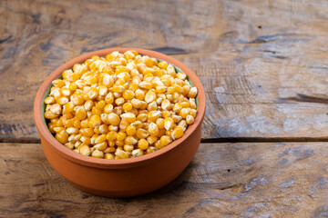 Bowl of Dry Corn Kernels on Rustic Surface