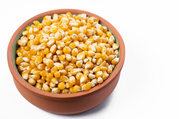 Bowl with popcorn kernels on a white background