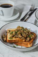 mushroom toast on plate in hard light